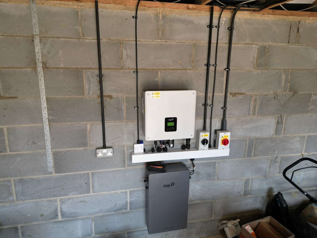 Solar inverter and battery storage system mounted on a garage wall