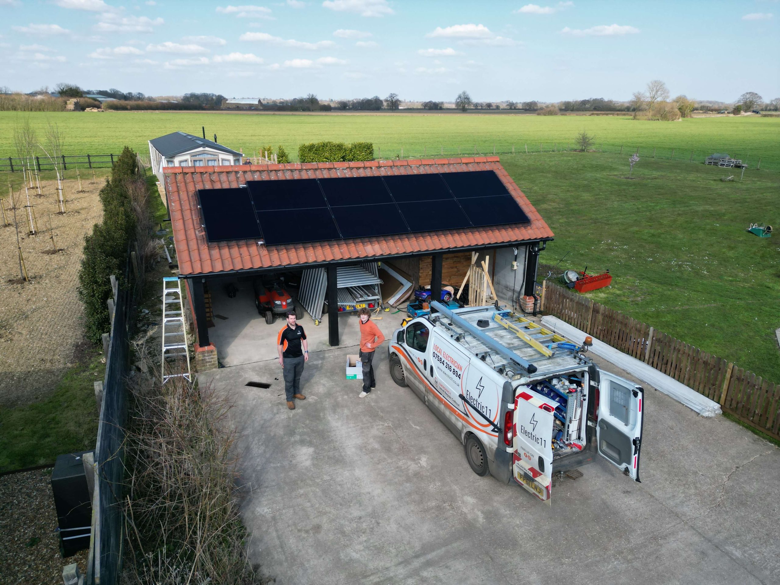 Aerial view of Electric11 solar panel installation on a garage roof in a rural property