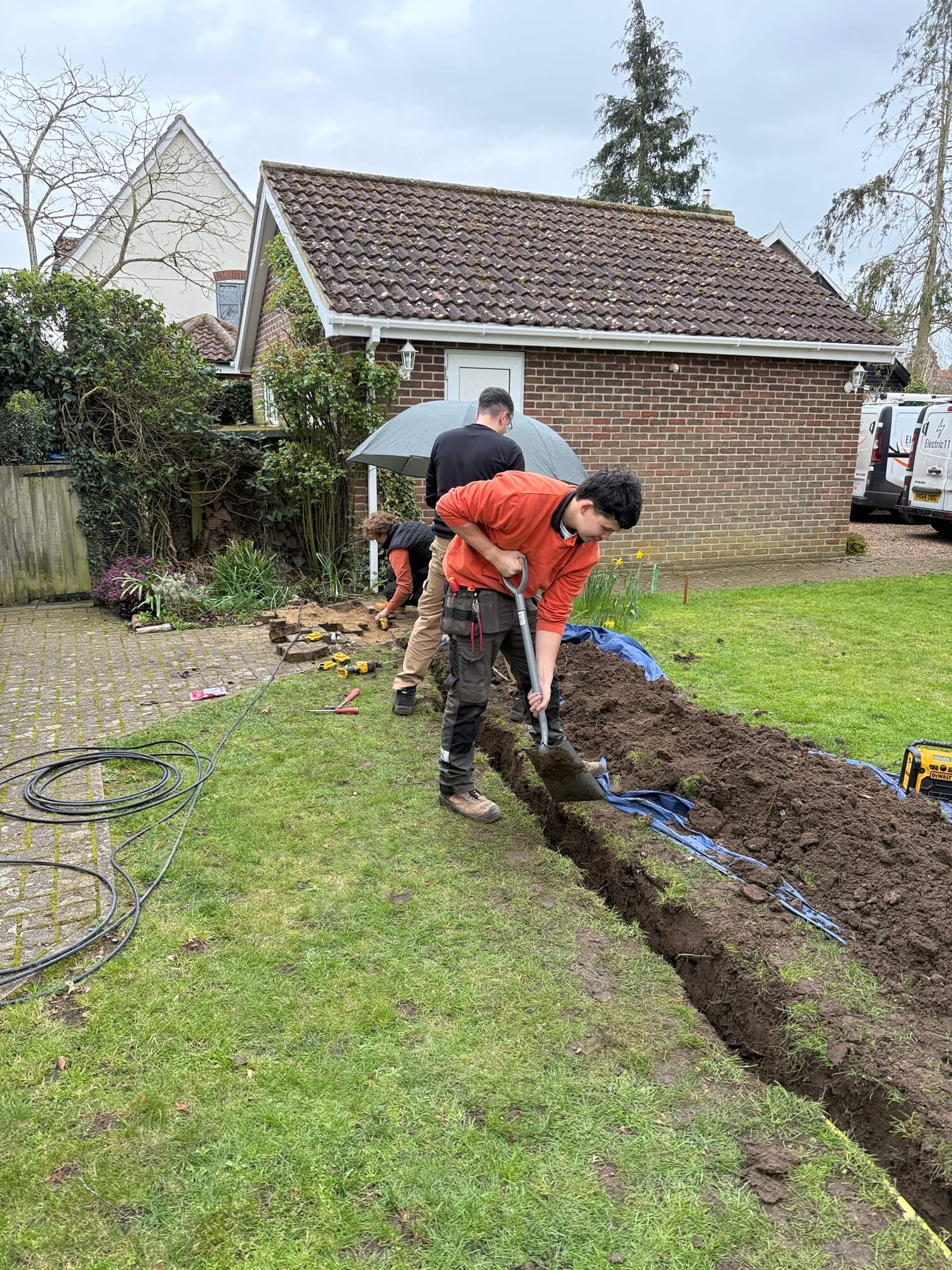Electric11 team digging the underground cable trench across the front garden