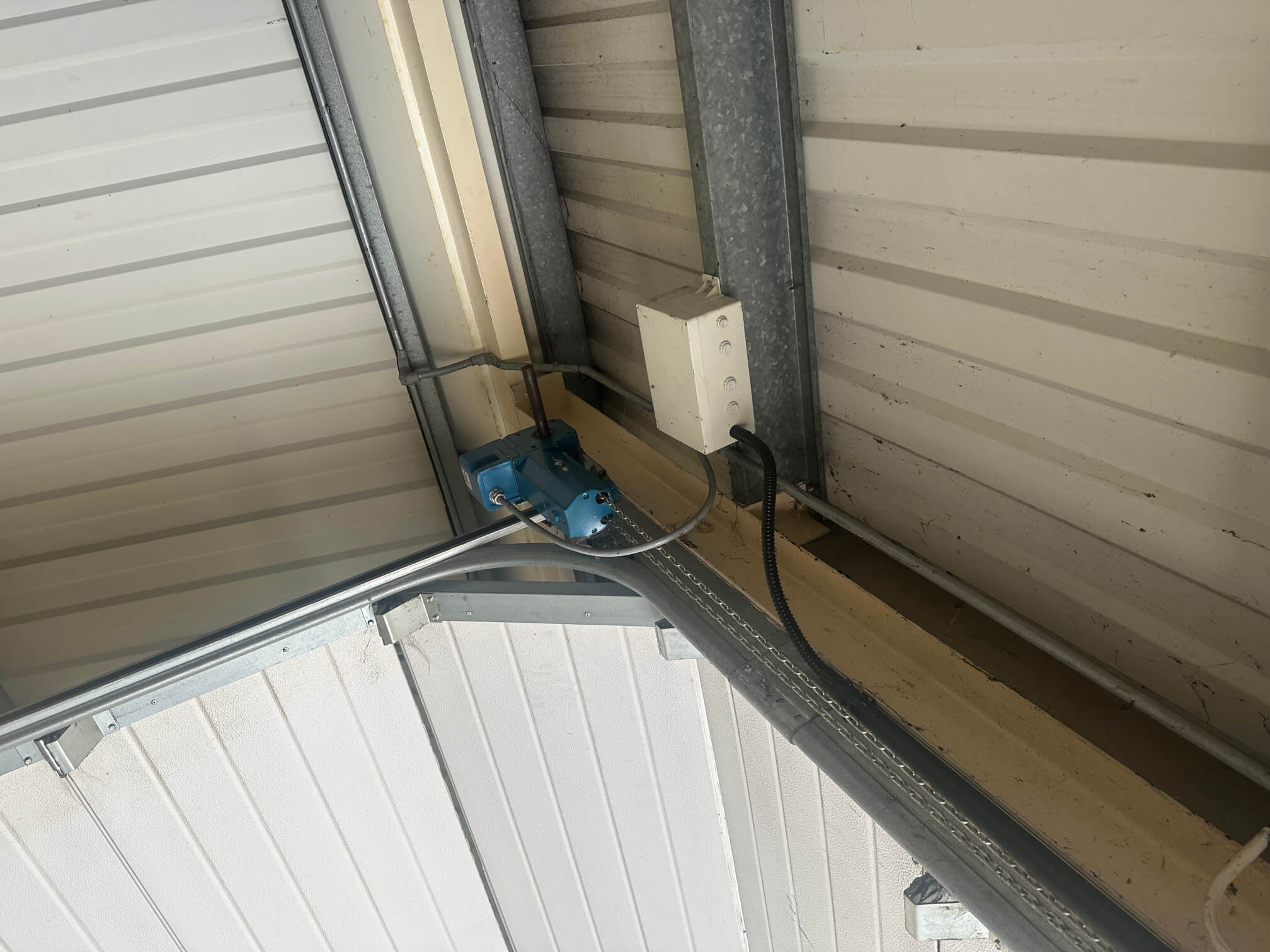 Roller shutter door motor and junction box in a workshop