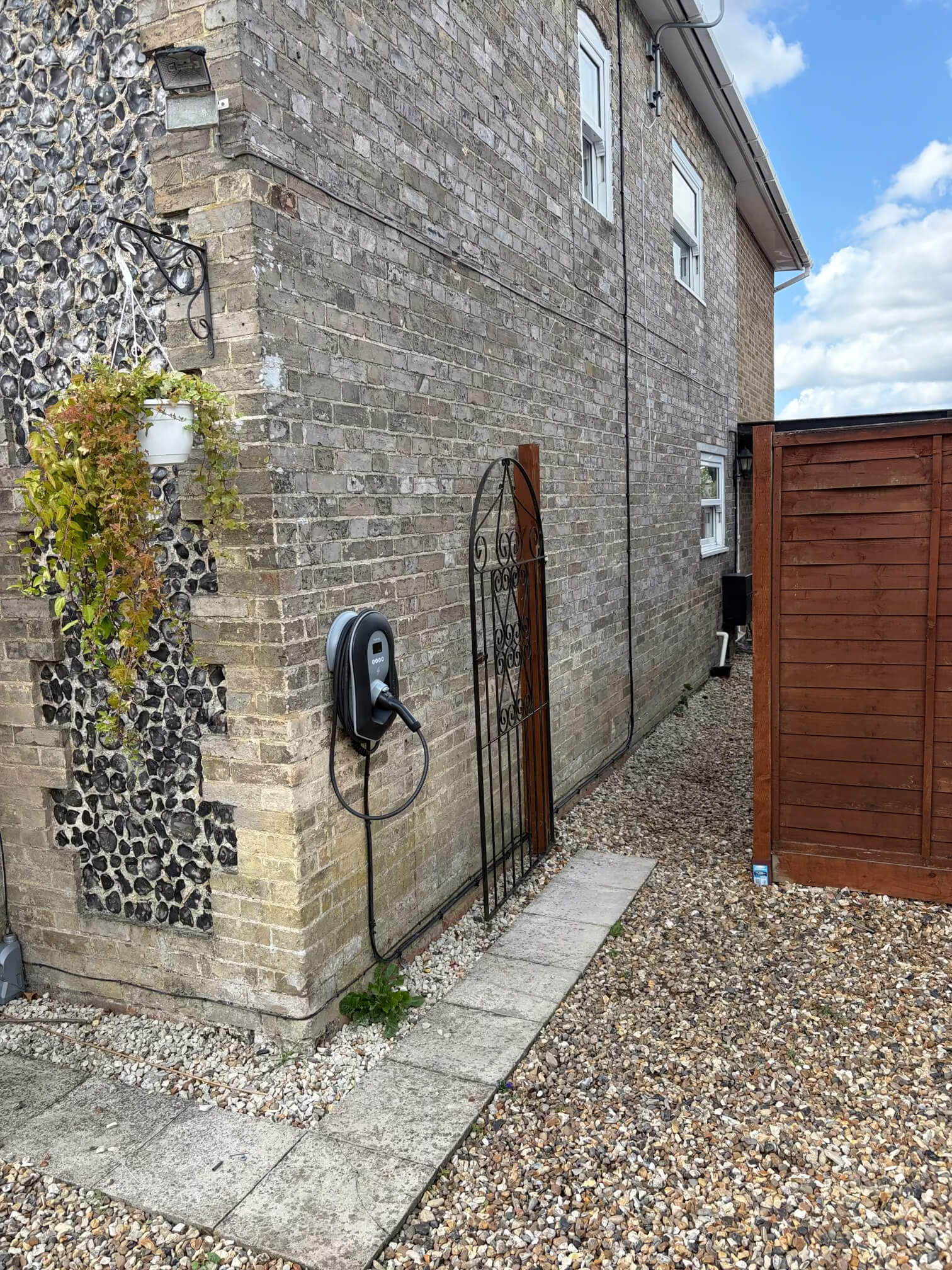 Home Zappi charger mounted beside a pathway at a Watton-area property