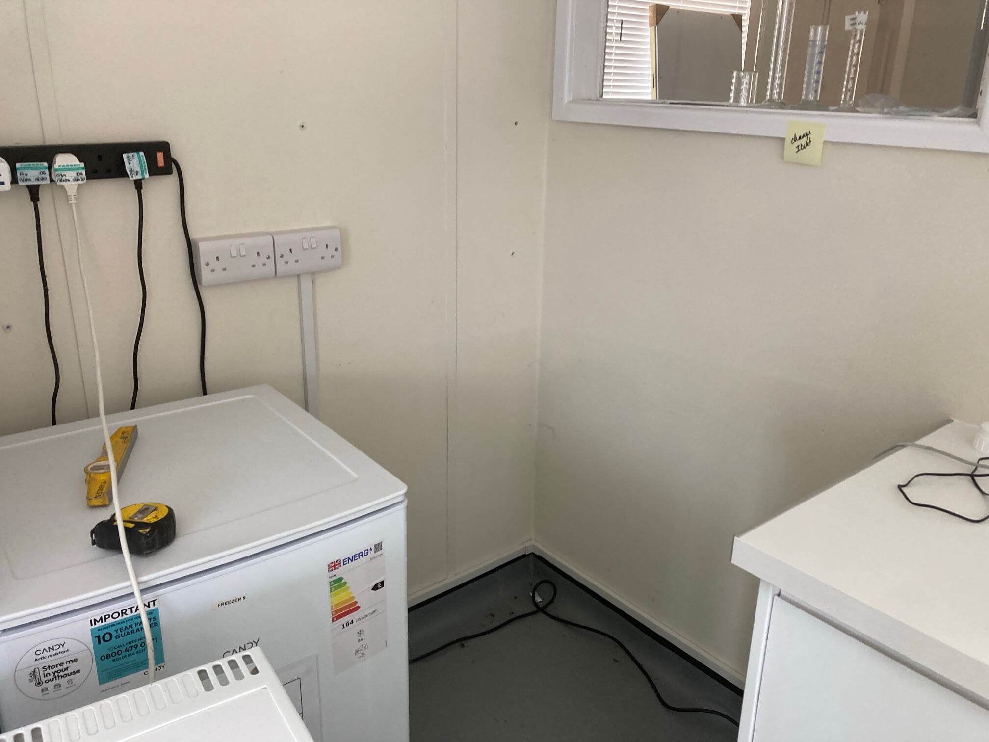 Laboratory freezer area with accessible wall-mounted power sockets