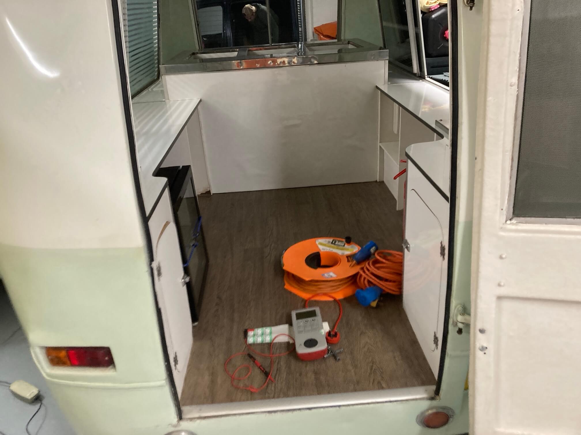PAT test equipment set up inside a mobile ice cream van in Wicklewood