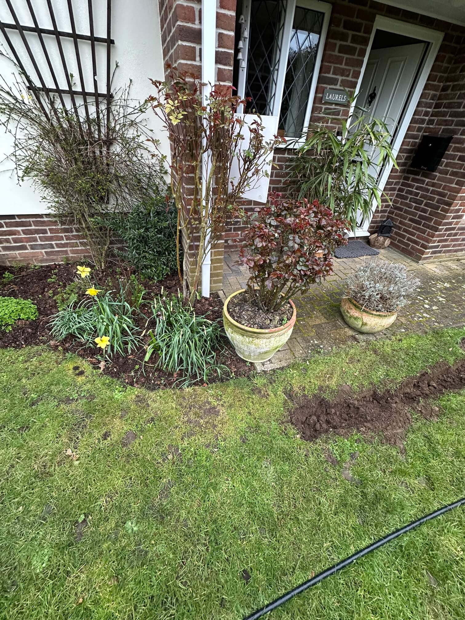 Planned underground cable route from the house towards the detached garage