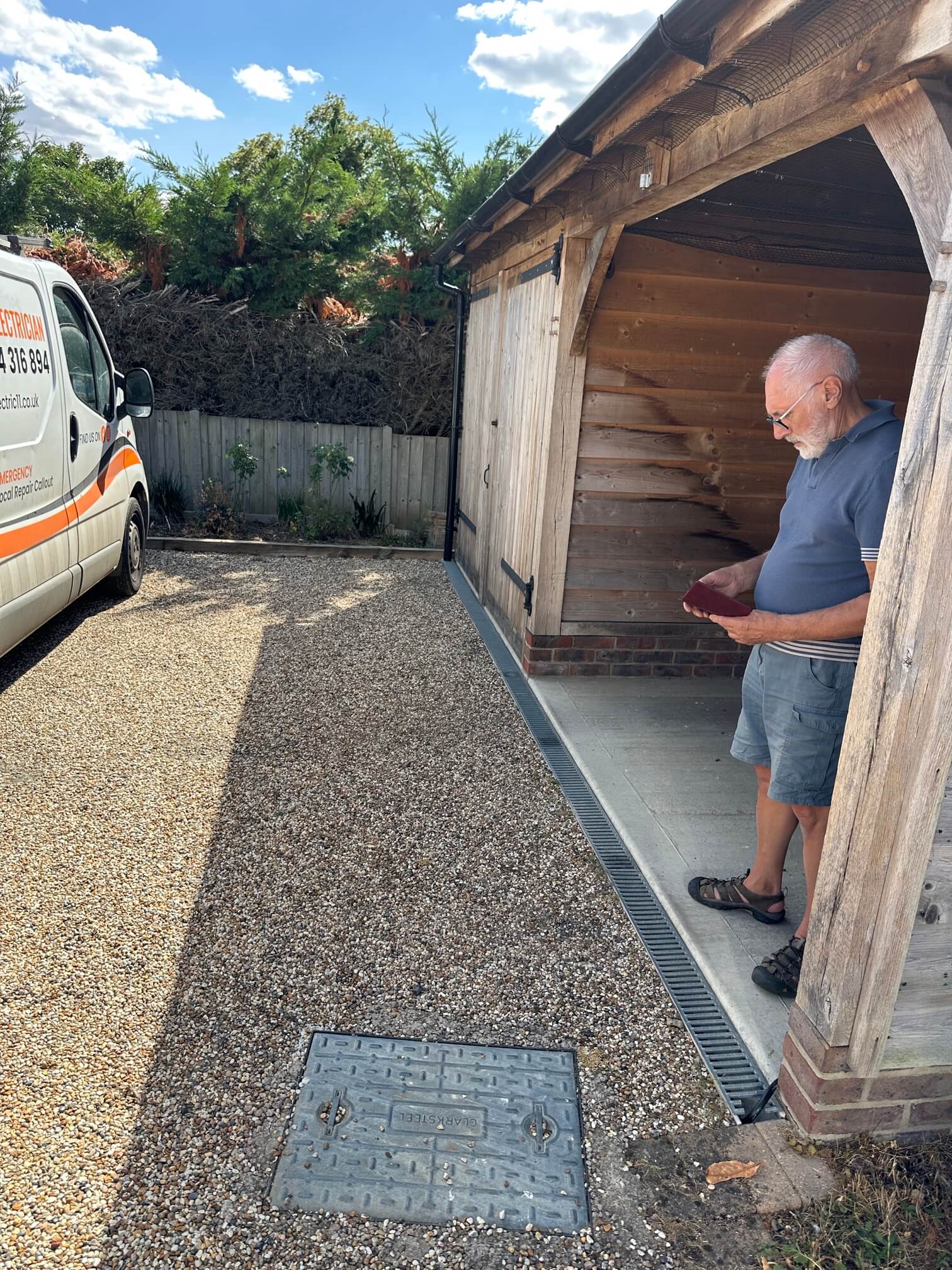 Customer viewing the new Zappi charger position beside the parking area
