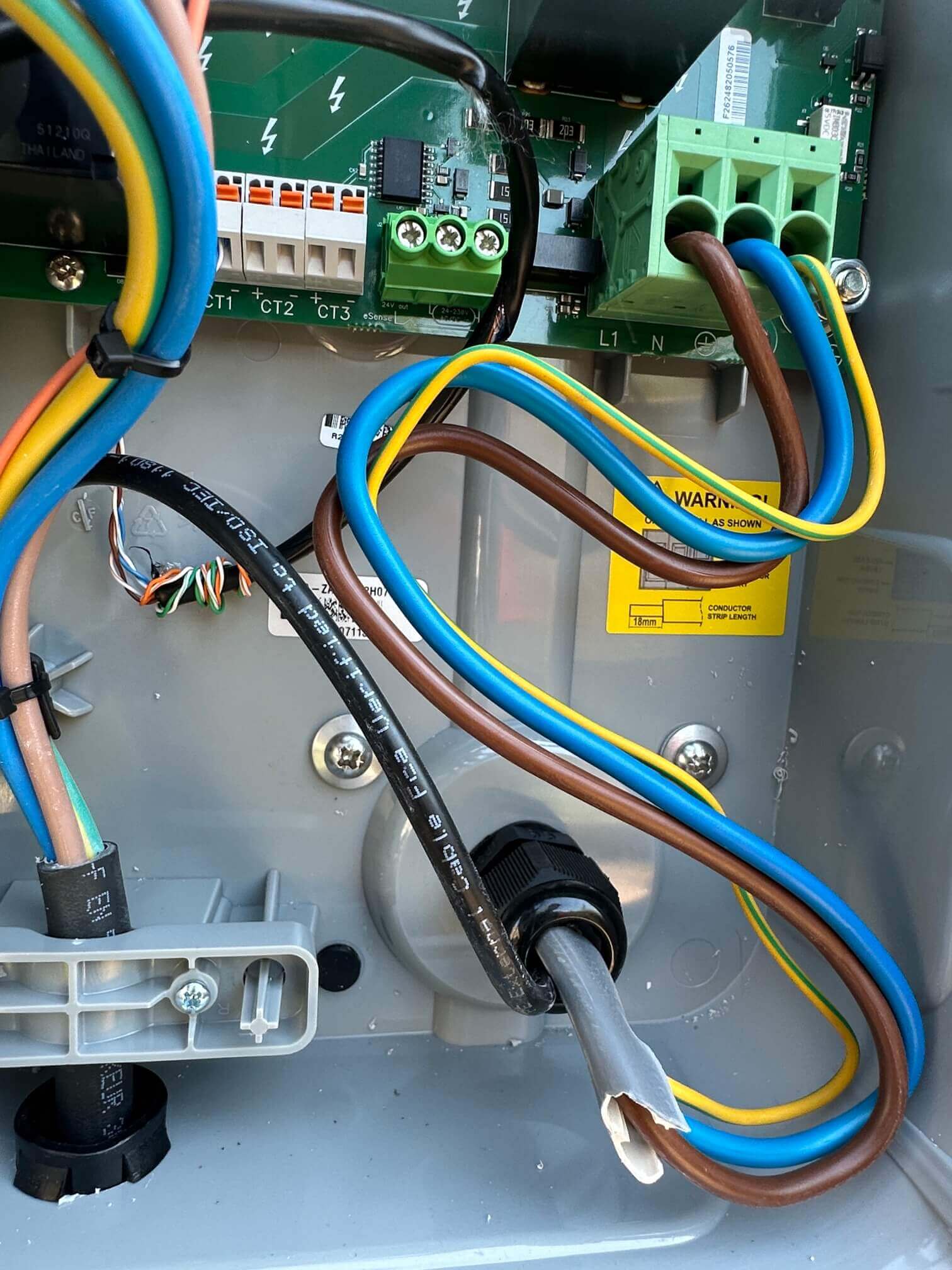 Detailed view of the internal supply and CT wiring inside a Zappi EV charger