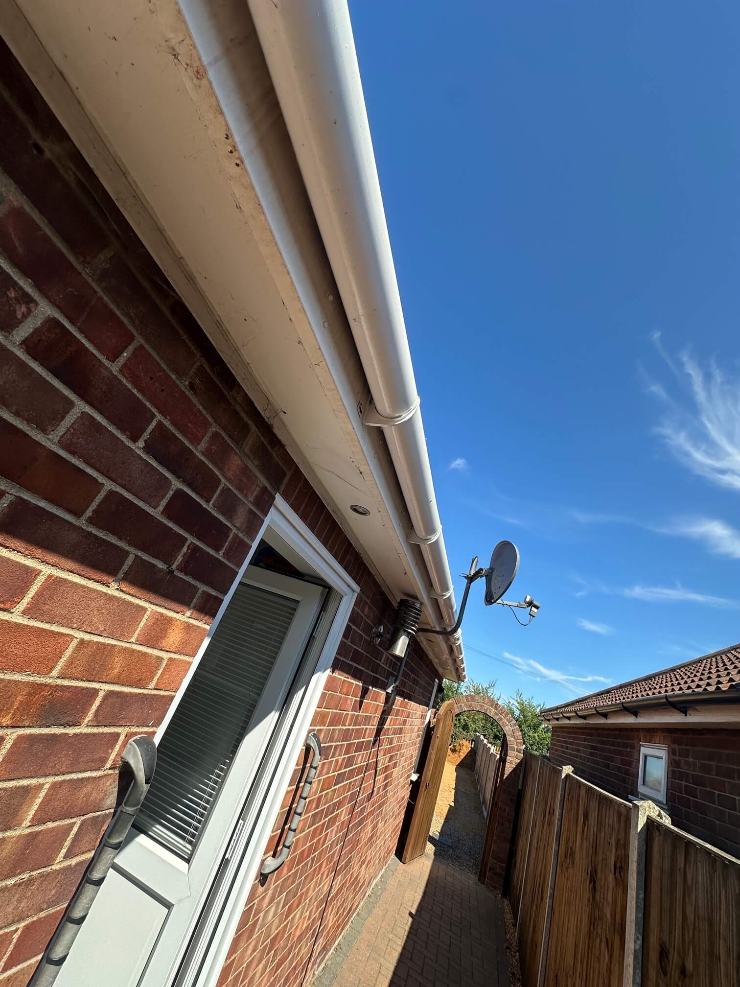 Small recessed light in the soffit above a brick exterior wall