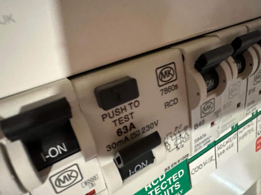 Close-up of existing RCD switches inside the property's consumer unit